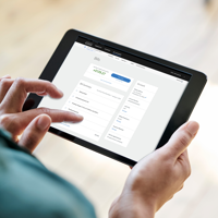 two hands holding tablet computer and touching screen